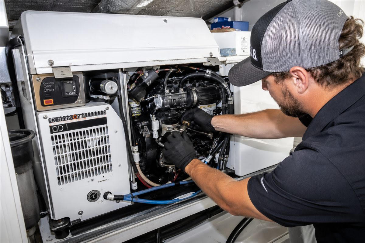 Universal Marine Service technician servicing a Cummins Onan marine generator