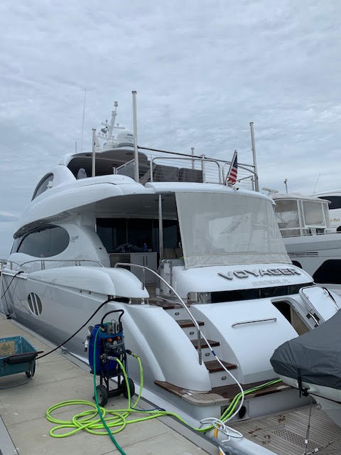 Marine plumbing and washdown equipment staged on a yacht's swim platform