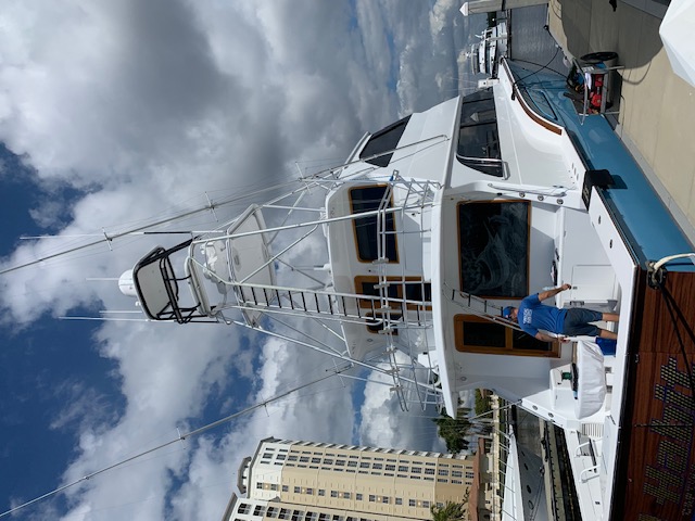Universal Marine Service technician working aboard a sportfishing boat's tower